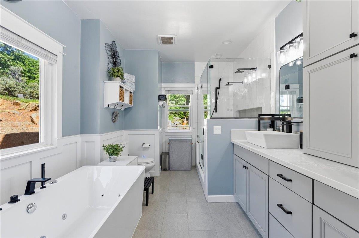 10784 Cole Way Grass Valley, CA 95945 - Photo 23 of 57 a bathroom with a tub sink and a window