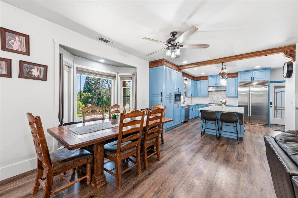 10784 Cole Way Grass Valley, CA 95945 - Photo 10 of 57 a dining room with furniture a rug and wooden floor