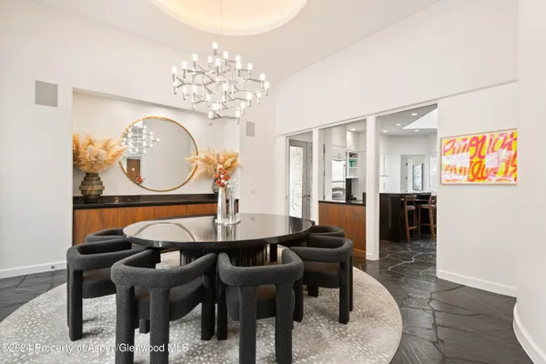 a view of a dining room with furniture and chandelier