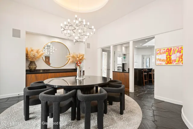 a view of a dining room with furniture and chandelier