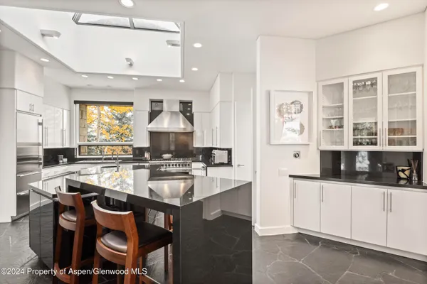 a kitchen with a sink stove and cabinets