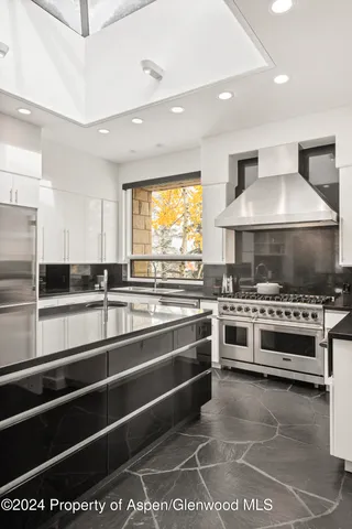 a kitchen with stainless steel appliances and a stove top oven