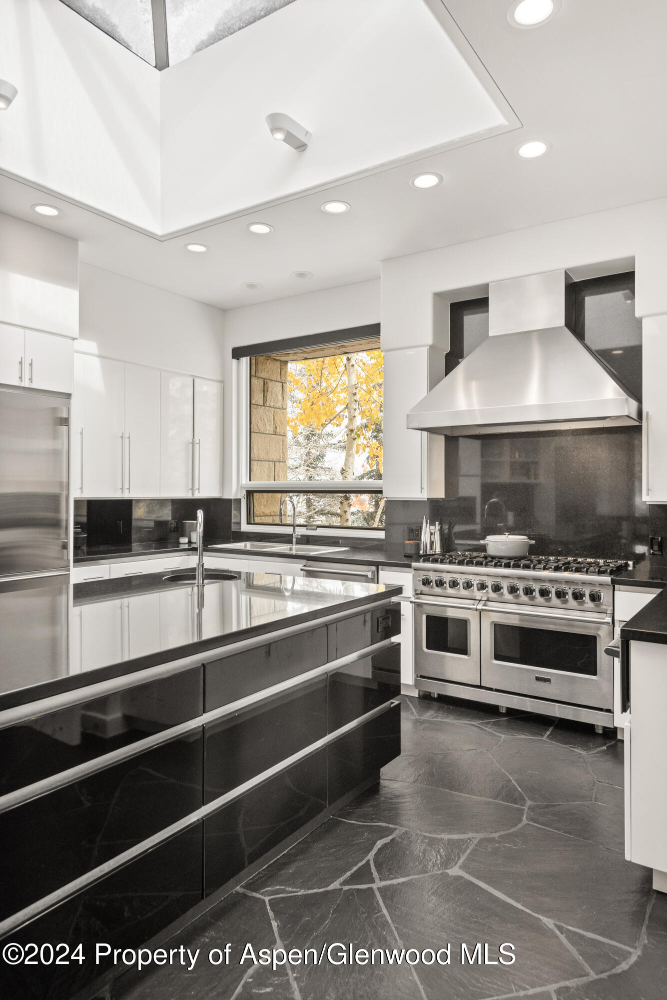 189 Aspen Way Snowmass Village, CO 81615 - Photo 16 of 44 a kitchen with stainless steel appliances and a stove top oven
