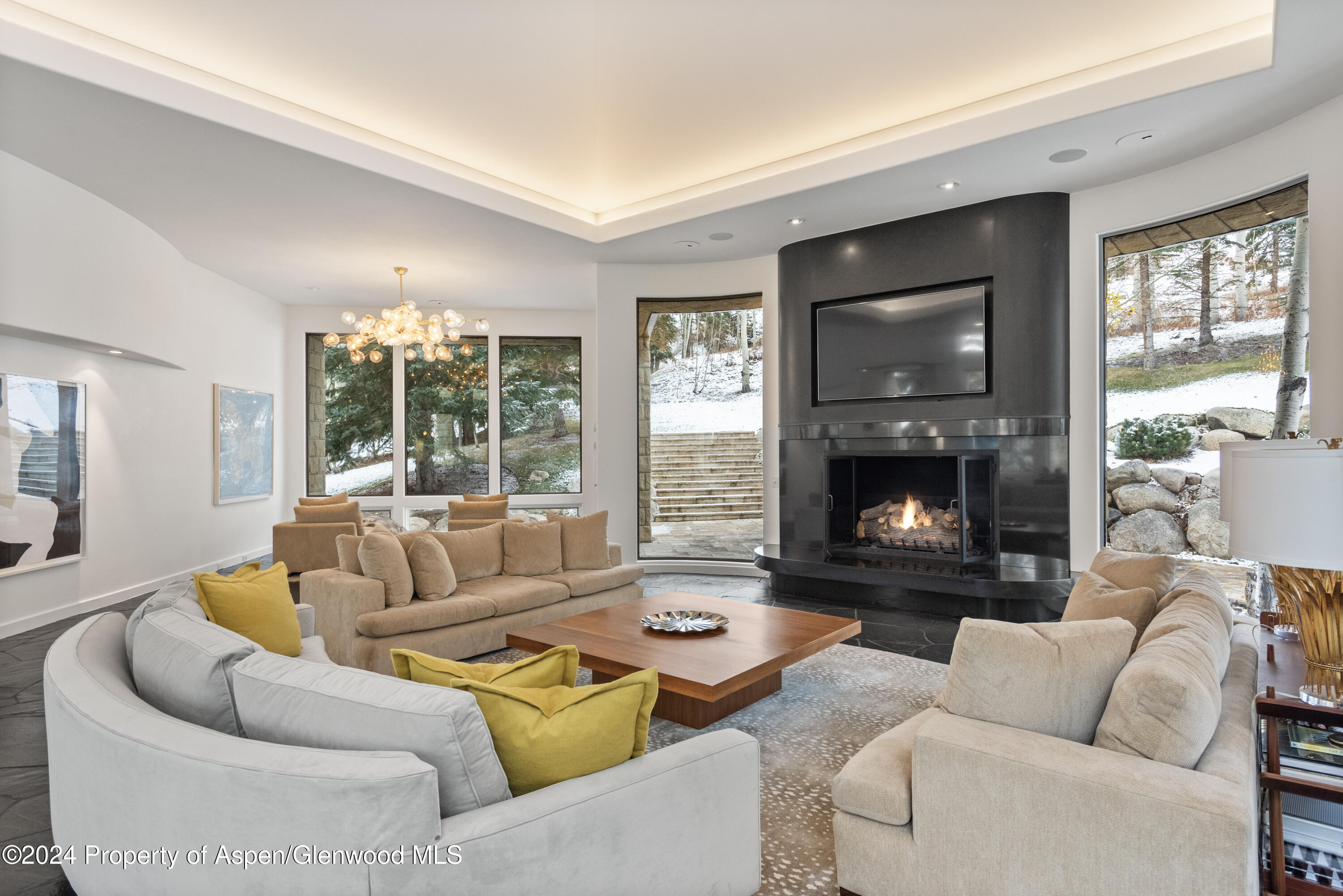 189 Aspen Way Snowmass Village, CO 81615 - Photo 2 of 44 a living room with furniture and a fireplace