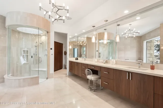 a large bathroom with a double vanity sink mirror and shower