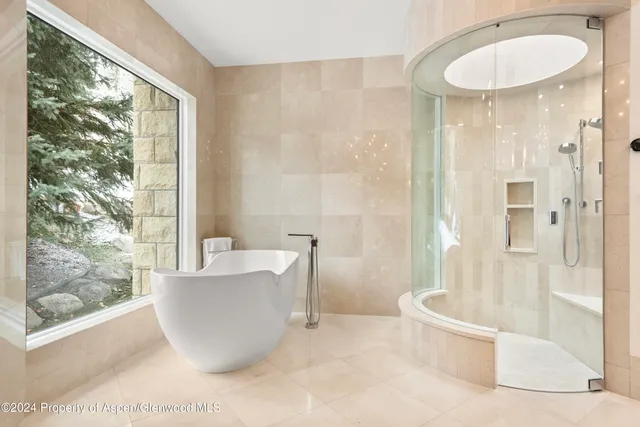 a living room with a large window and furniture