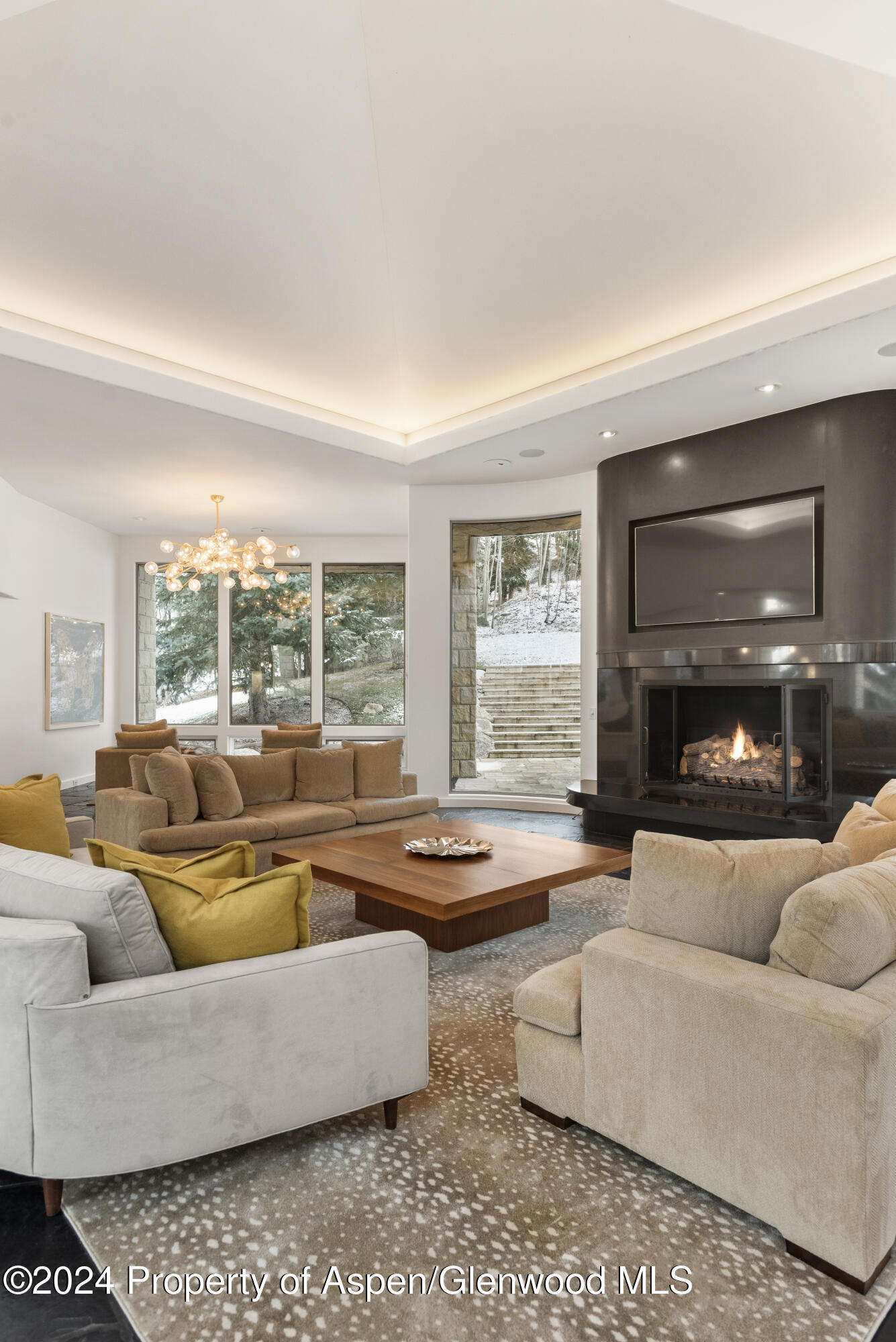 189 Aspen Way Snowmass Village, CO 81615 - Photo 3 of 44 a living room with fireplace furniture and a large window