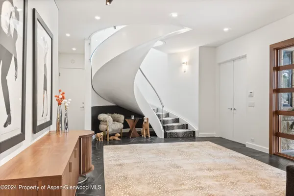 a living room with furniture and a mirror