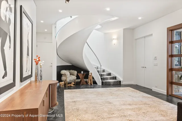 a living room with furniture and a mirror