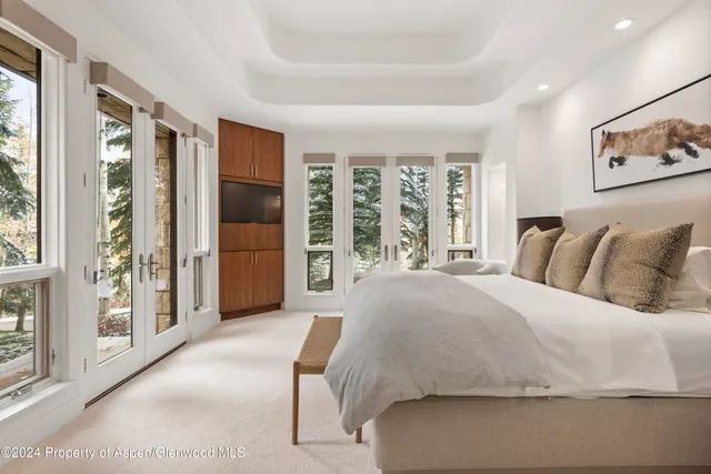 a spacious bedroom with a bed and a couch