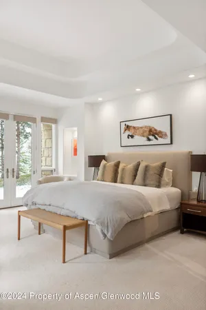 a bathroom with a granite countertop sink a mirror and shower