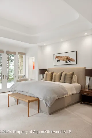 a bathroom with a granite countertop sink a mirror and shower
