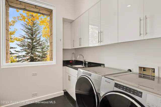 a brick building with a tree in front