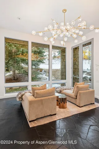 a living room with furniture and large windows