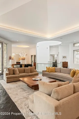 a living room with furniture and a large mirror