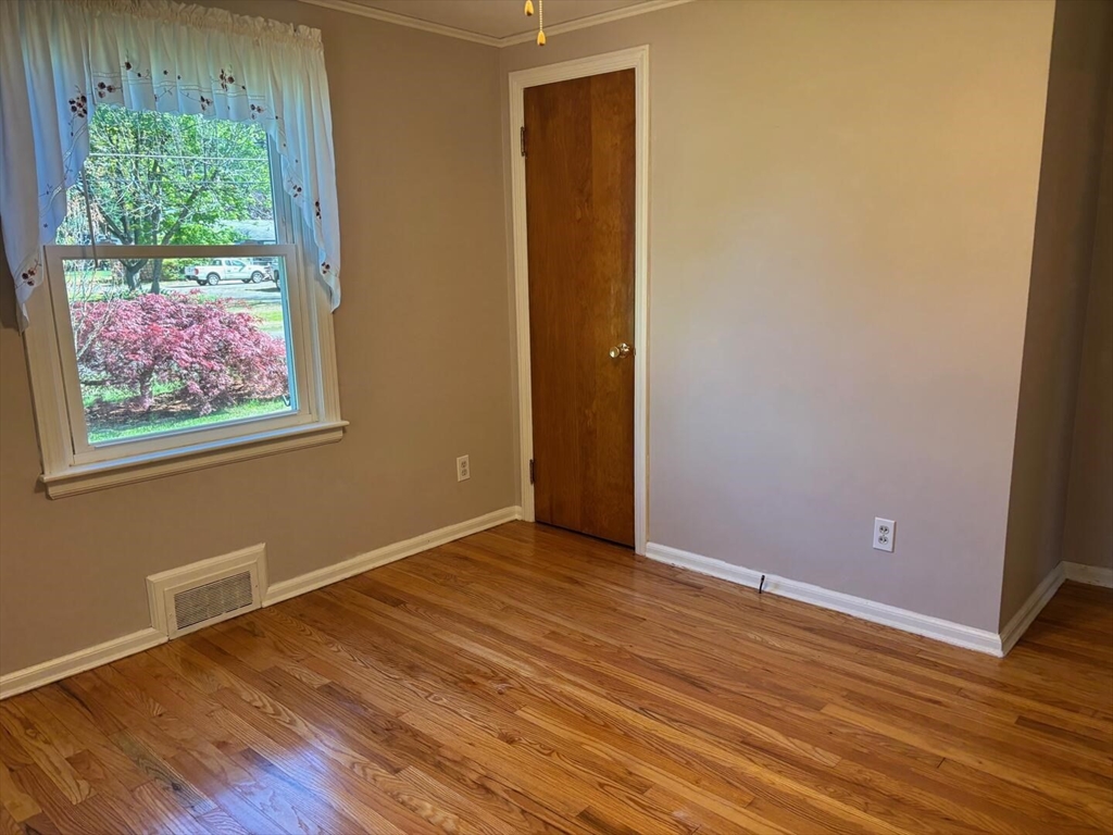 65 Brookside Circle Springfield, MA 01129 - Photo 22 of 25 a view of an empty room with wooden floor and a window