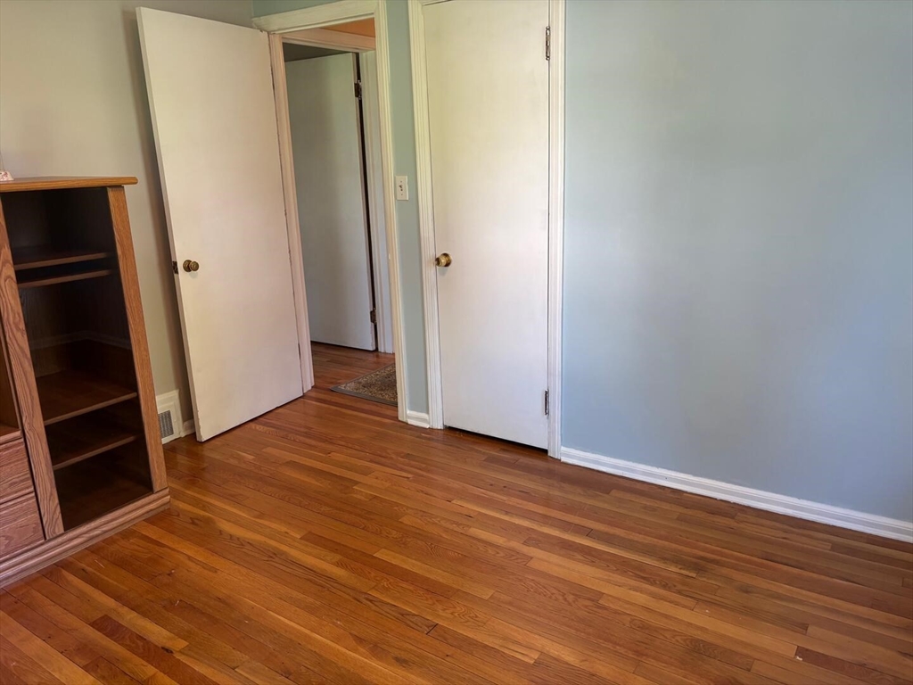 65 Brookside Circle Springfield, MA 01129 - Photo 24 of 25 a view of an empty room with wooden floor and a window