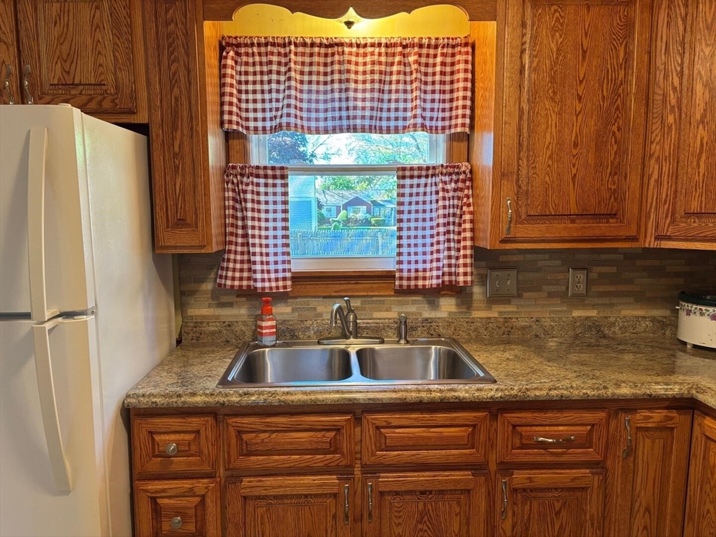 65 Brookside Circle Springfield, MA 01129 - Photo 10 of 25 a kitchen with a sink and a refrigerator