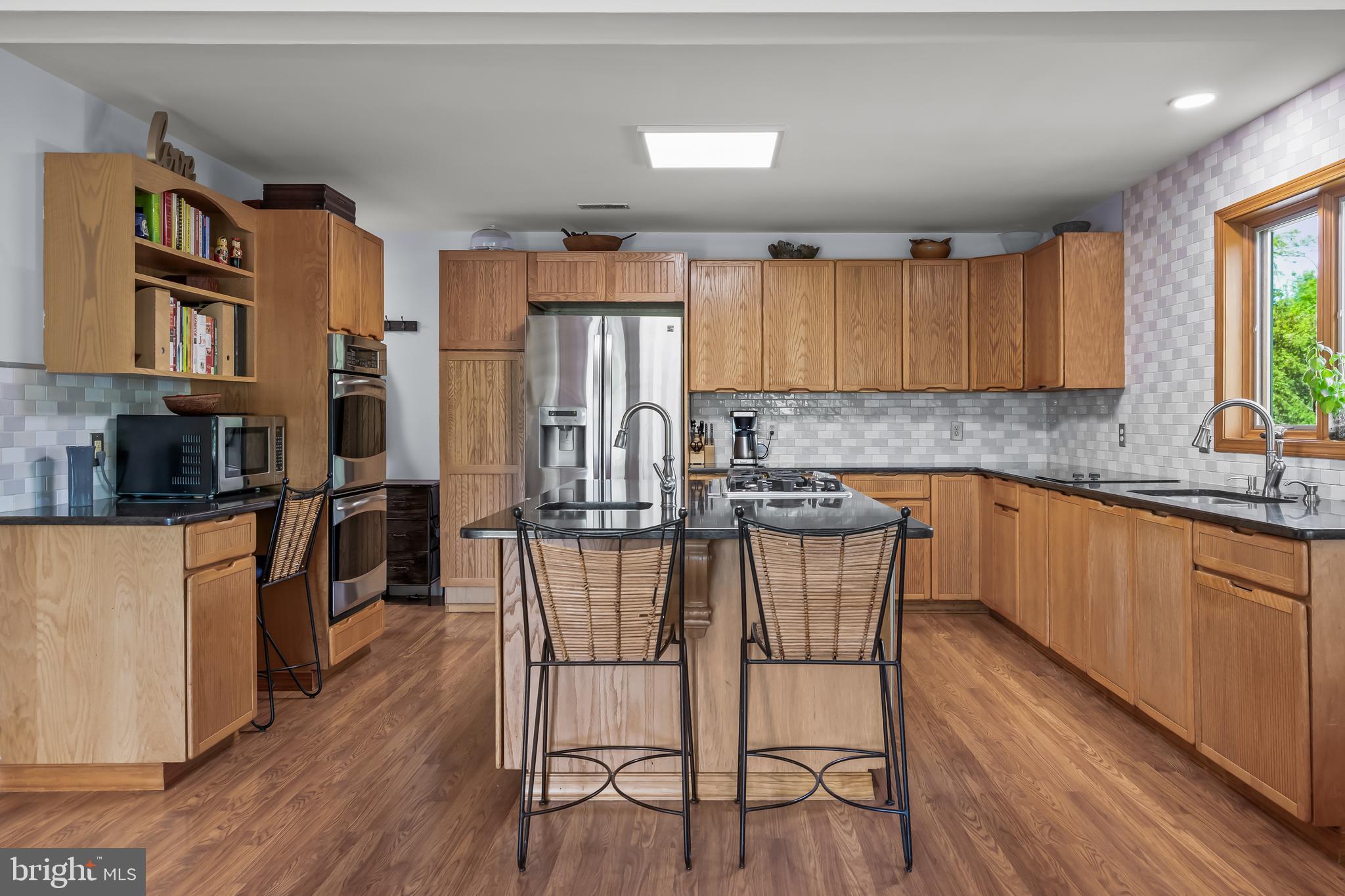 10 Marriott Drive Lumberton, NJ 08048 - Photo 15 of 60 a kitchen with stainless steel appliances wooden floors and wooden cabinets