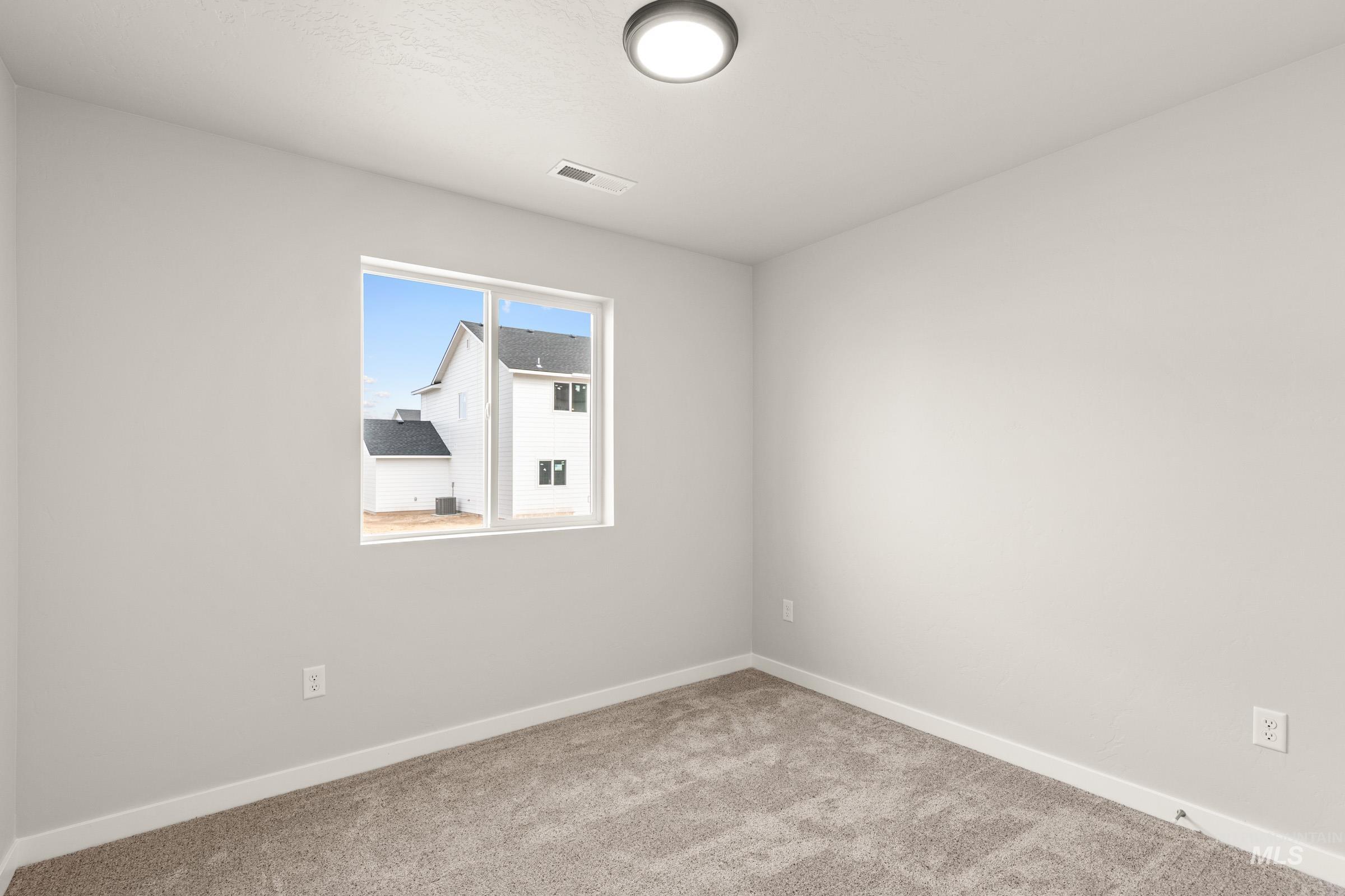 13704 Redway Court Caldwell, ID 83607 - Photo 11 of 23 Unfurnished room featuring baseboards and light carpet