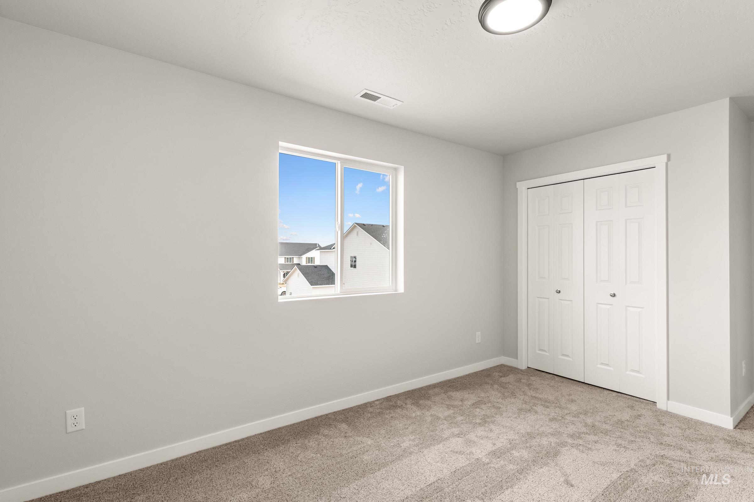 13704 Redway Court Caldwell, ID 83607 - Photo 14 of 23 Unfurnished bedroom with light carpet and a closet