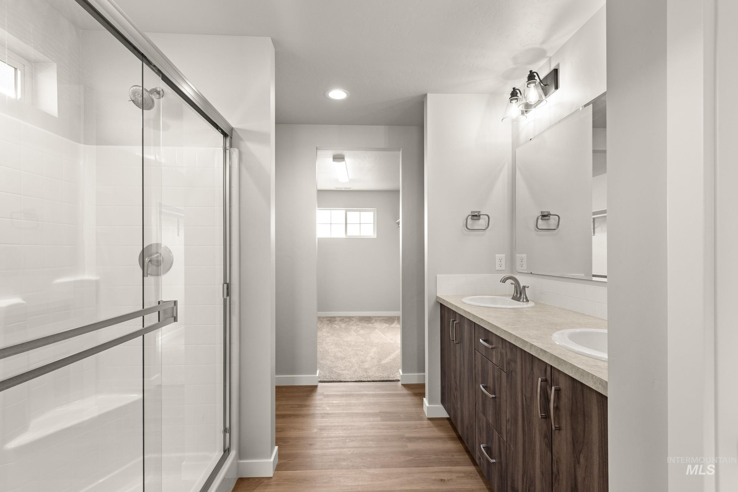 13704 Redway Court Caldwell, ID 83607 - Photo 17 of 23 Bathroom featuring double vanity, light wood finished floors, a stall shower, and recessed lighting
