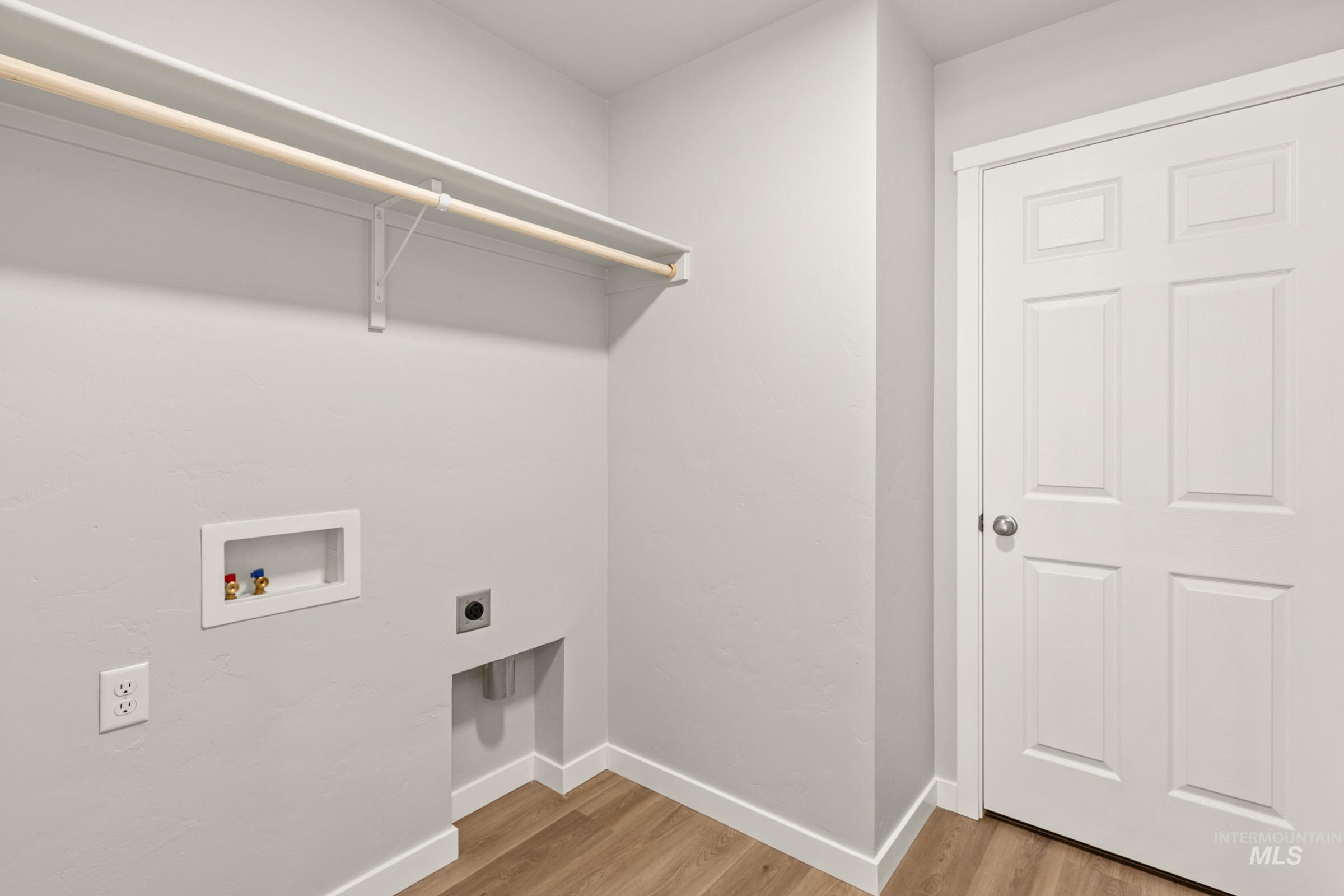 13704 Redway Court Caldwell, ID 83607 - Photo 19 of 23 Laundry room featuring light wood-type flooring, electric dryer hookup, and washer hookup