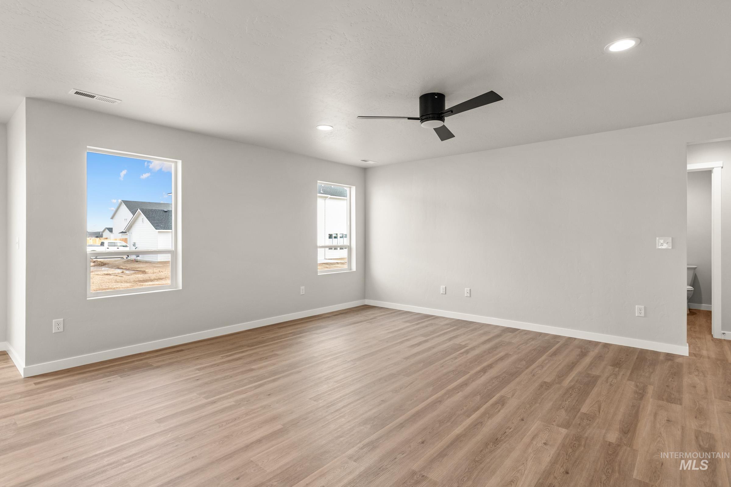 13704 Redway Court Caldwell, ID 83607 - Photo 8 of 23 Empty room featuring ceiling fan, light wood-type flooring, and recessed lighting