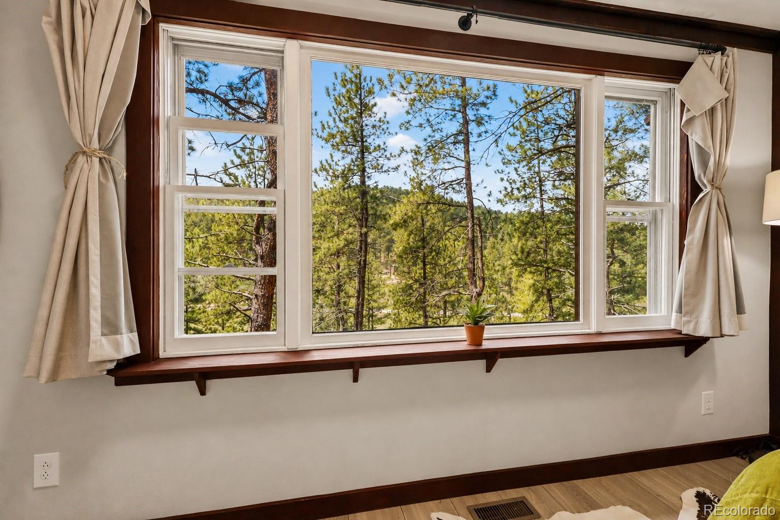 7520 South Blue Creek Road Evergreen, CO 80439 - Photo 8 of 22 a view of a large window with a balcony
