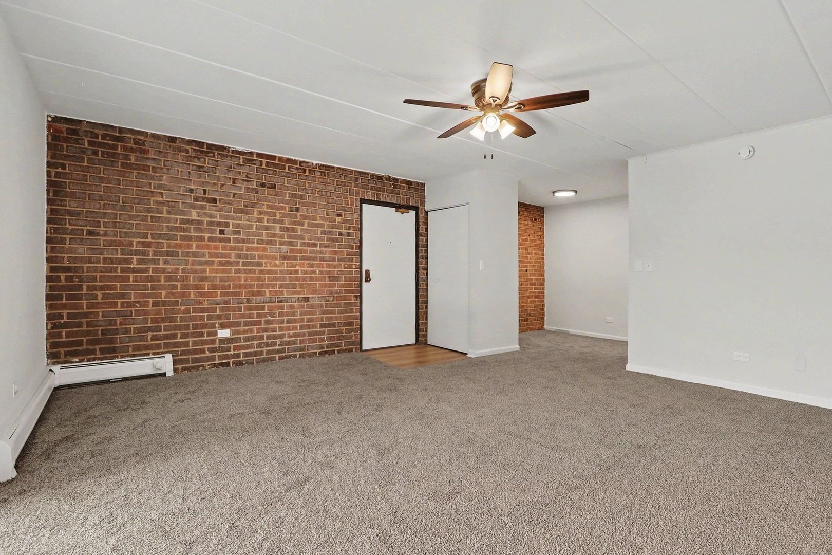228 East Bailey Road, Unit F Naperville, IL 60565 - Photo 6 of 16 a view of an empty room with a ceiling fan and window