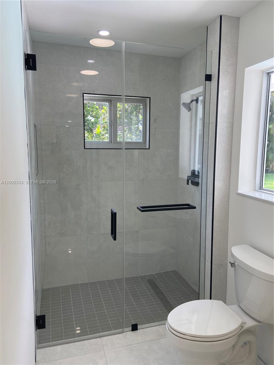 9840 Southwest 69th Avenue Pinecrest, FL 33156 - Photo 11 of 24 a bathroom with a toilet and a shower