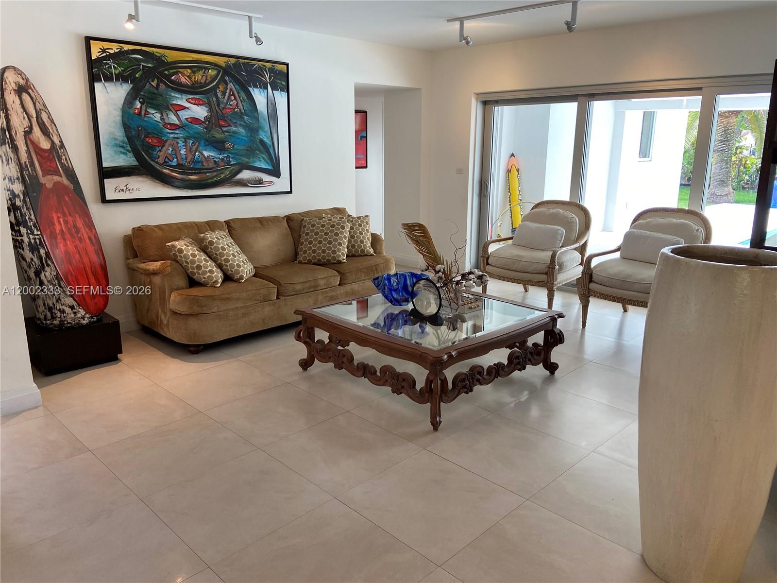 9840 Southwest 69th Avenue Pinecrest, FL 33156 - Photo 20 of 24 a living room with furniture a rug and a large window