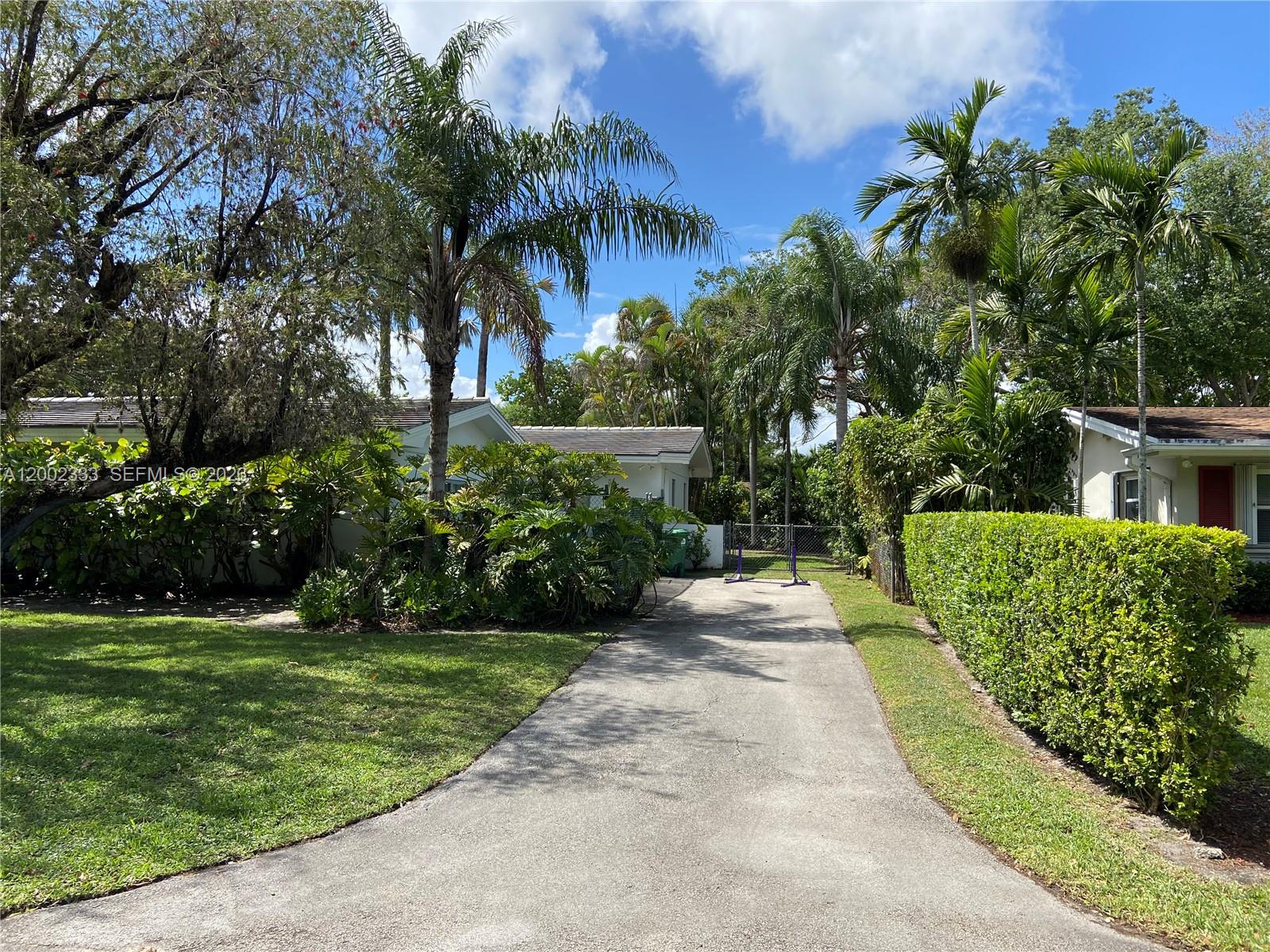 9840 Southwest 69th Avenue Pinecrest, FL 33156 - Photo 3 of 24 a view of a garden with palm trees
