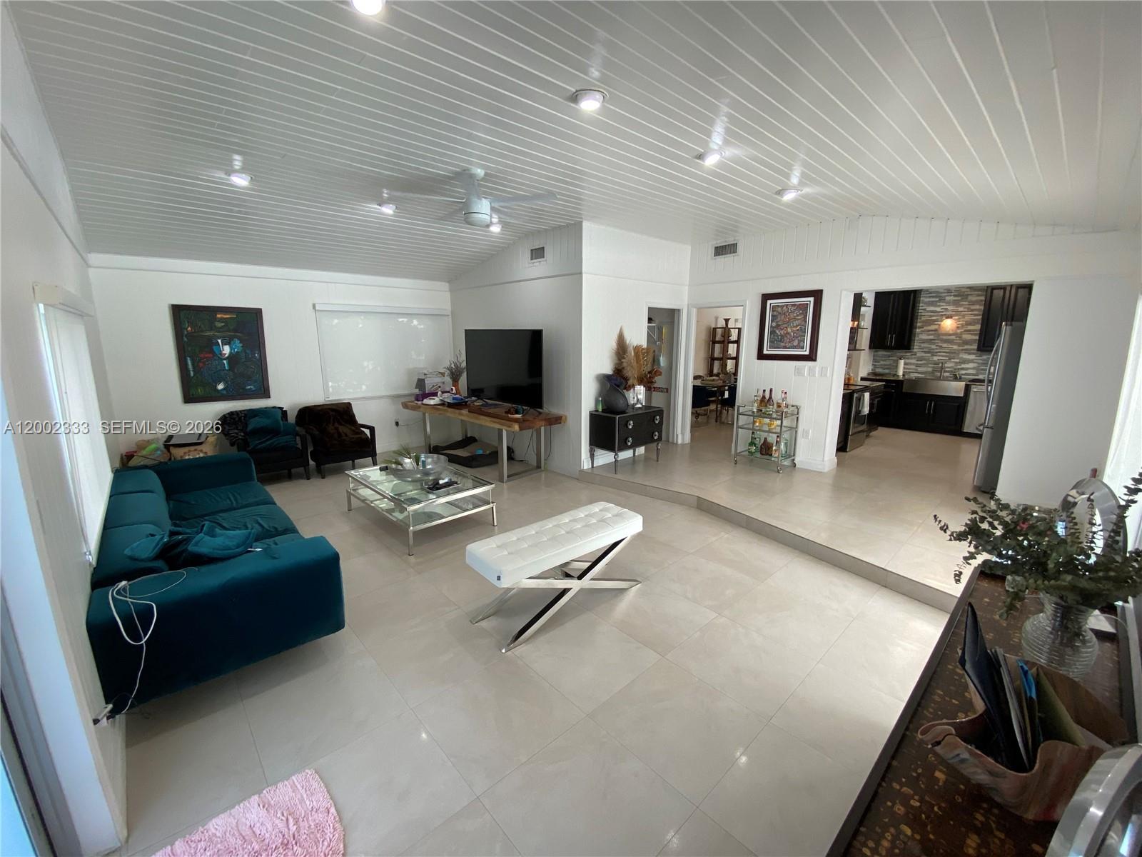 9840 Southwest 69th Avenue Pinecrest, FL 33156 - Photo 8 of 24 a living room with furniture and a flat screen tv