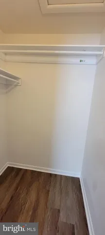 a view of a closet with wooden floor