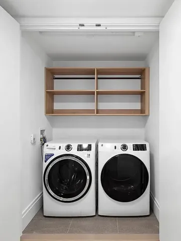 a bedroom with bed and a painting on the wall
