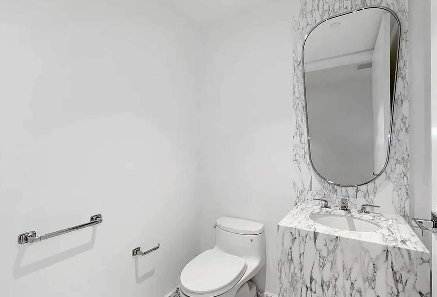 50 West 66th Street, Unit 7G Manhattan, NY 10023 - Photo 17 of 21 a bathroom with a granite countertop sink mirror vanity and toilet