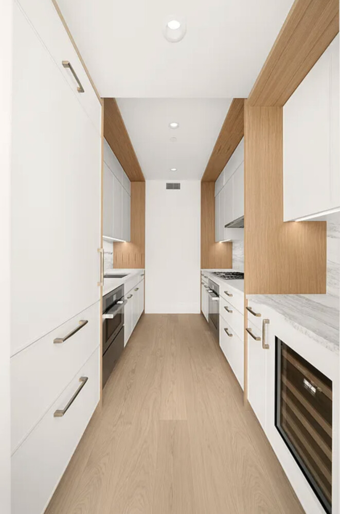 50 West 66th Street, Unit 7G Manhattan, NY 10023 - Photo 18 of 21 a kitchen with stainless steel appliances a refrigerator sink and stove