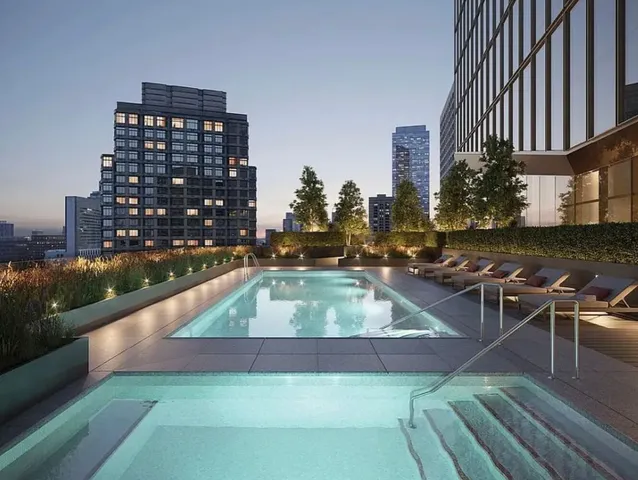 a view of a living room and chandelier stainless steel appliances