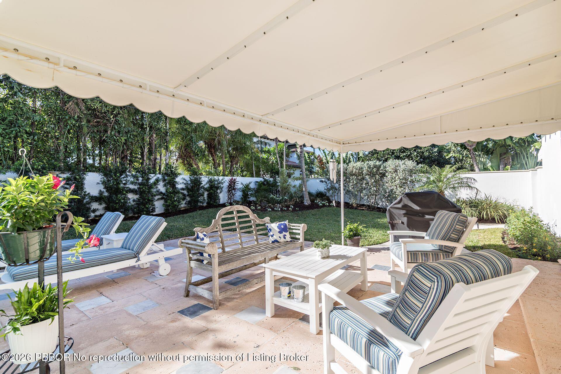 224 Churchill Road West Palm Beach, FL 33405 - Photo 23 of 33 a view of a patio with a table chairs and a potted plants