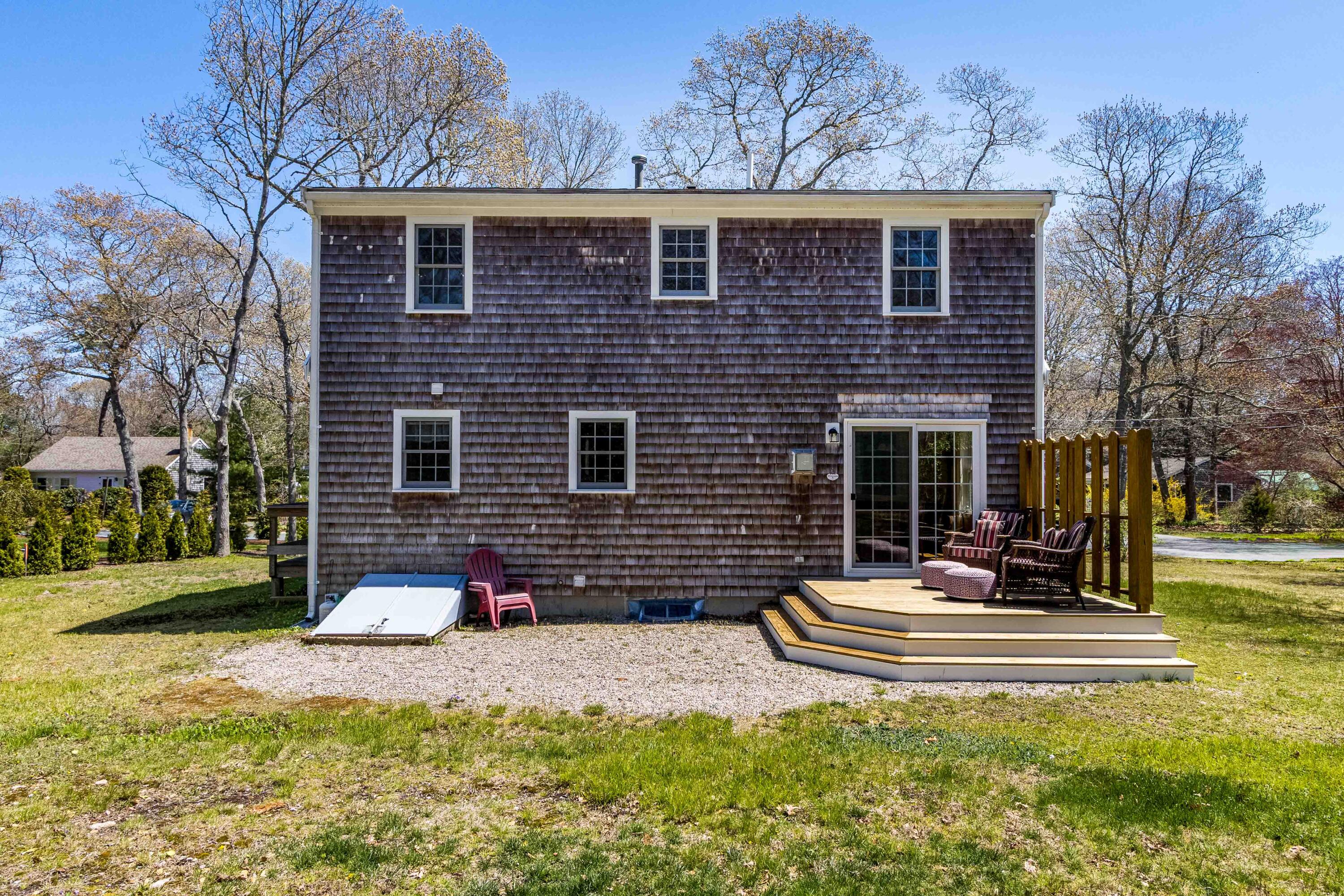 5 Raspberry Lane Marstons Mills, MA 02648 - Photo 20 of 29 a view of a house with a yard and a fire pit