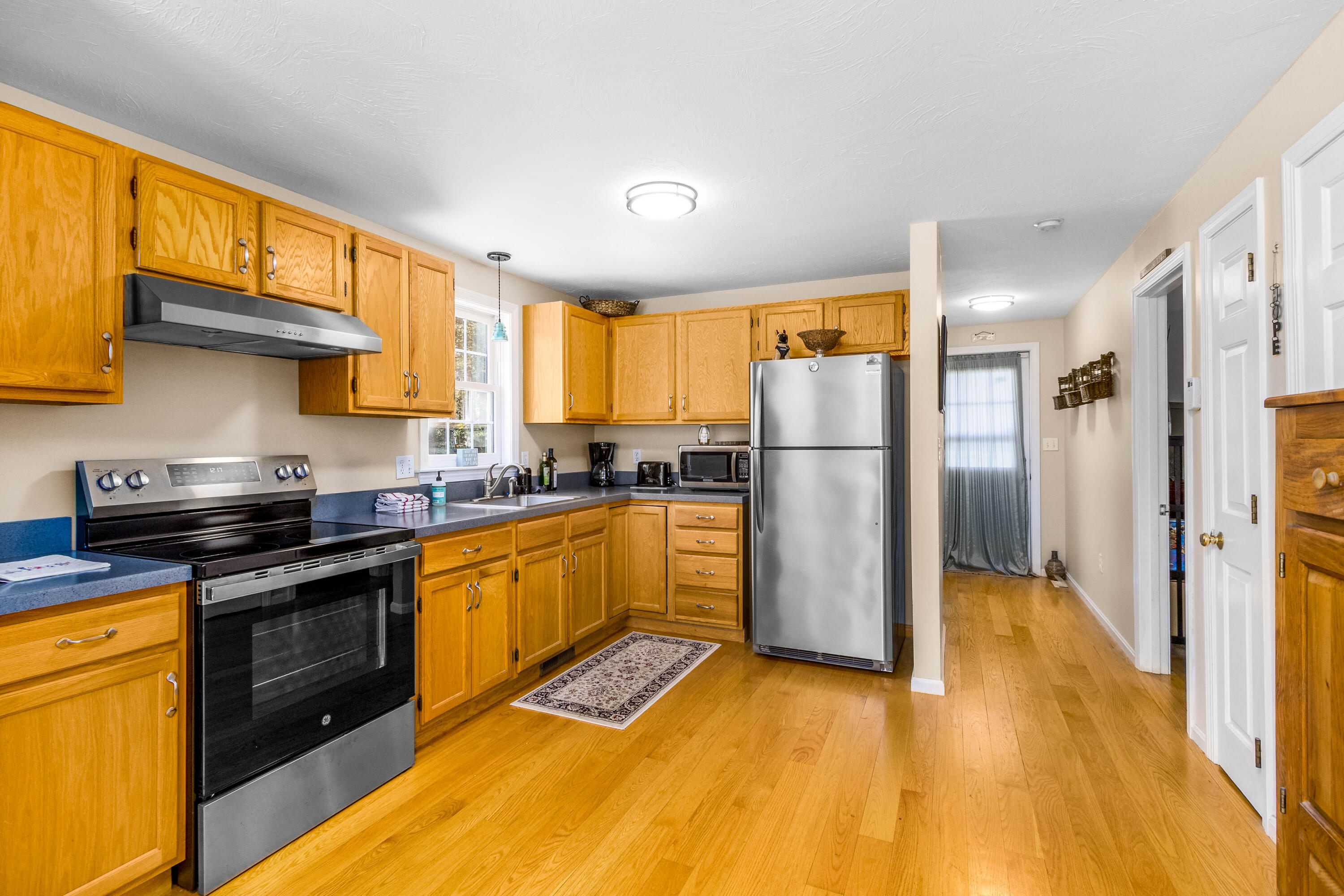 5 Raspberry Lane Marstons Mills, MA 02648 - Photo 9 of 29 a kitchen with stainless steel appliances granite countertop a refrigerator a stove top oven and a sink