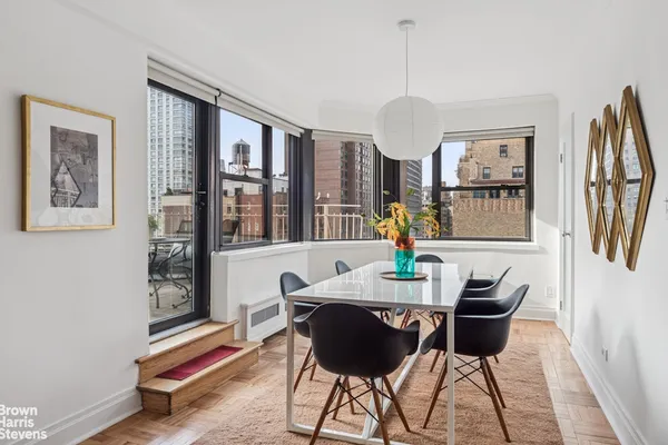 a dining room with furniture and window