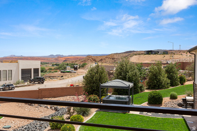 2591 East Washington Dam Road Washington, UT 84780 - Photo 24 of 67 Expansive backyard featuring a manicured lawn, established landscaping, and a covered hot tub