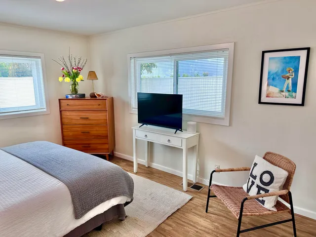 a bedroom with a bed and a flat screen tv
