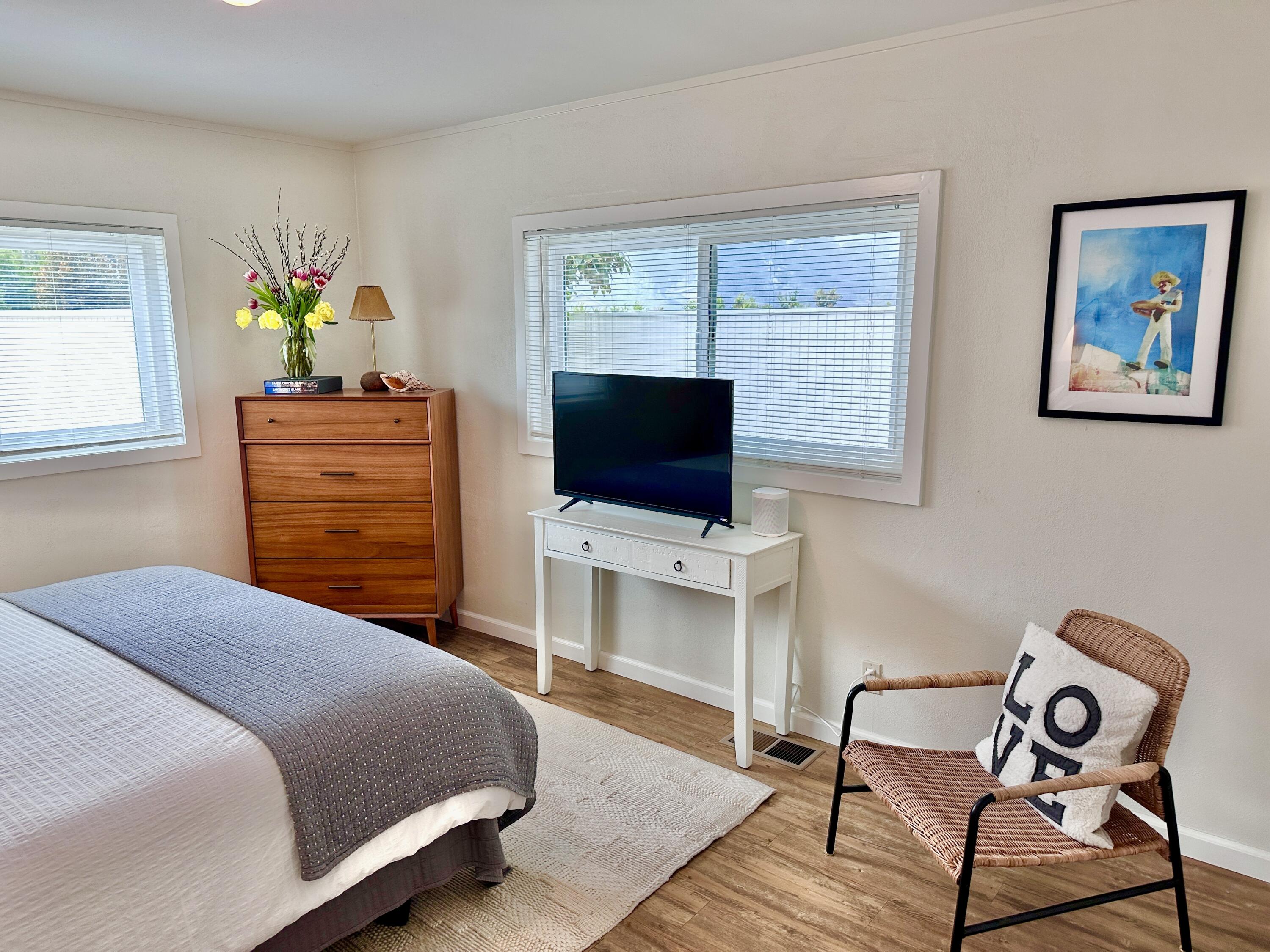 2227 Cliff Drive Santa Barbara, CA 93109 - Photo 13 of 26 a bedroom with a bed and a flat screen tv