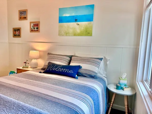 a bedroom with a bed and a wall painting