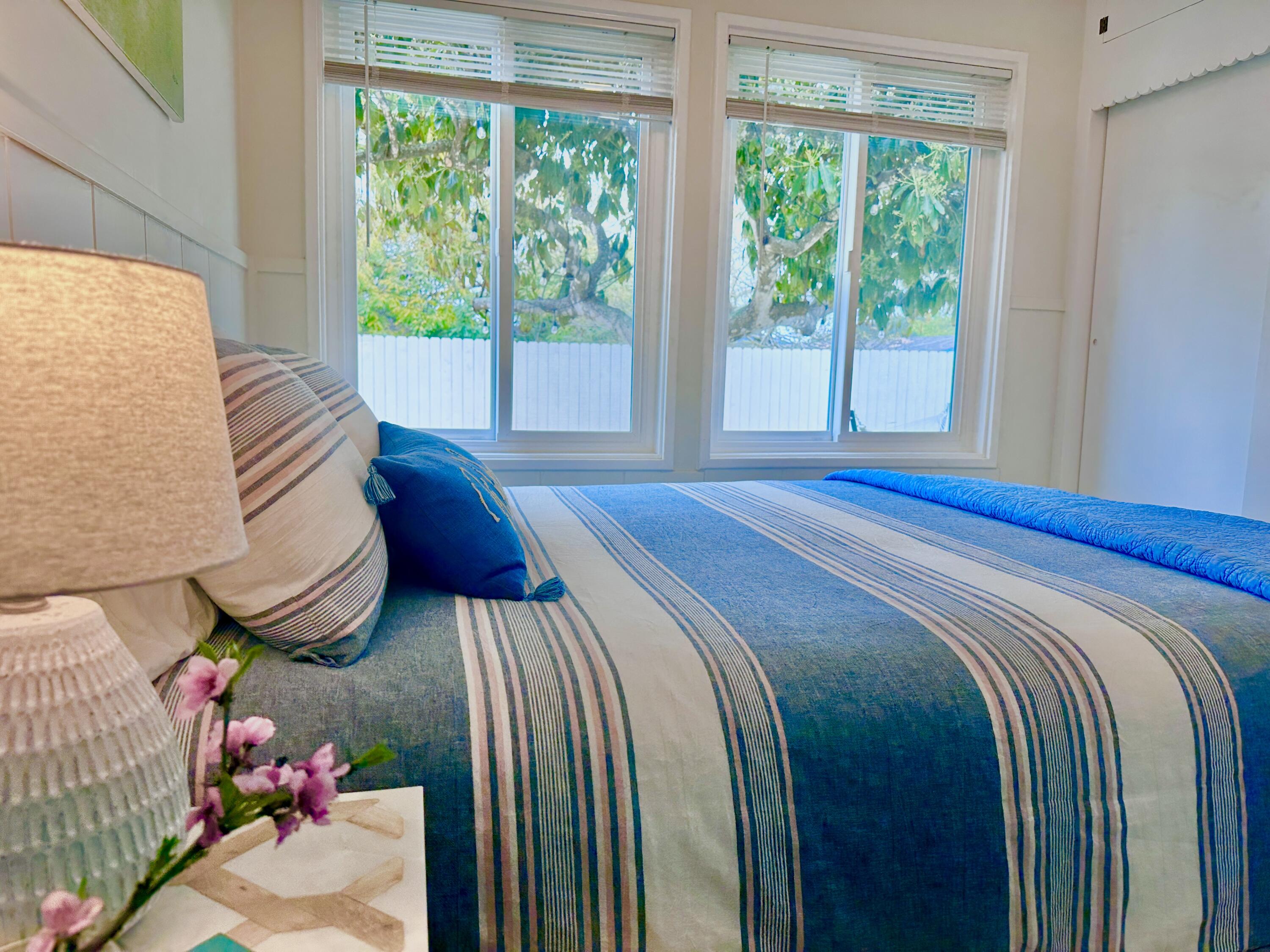 2227 Cliff Drive Santa Barbara, CA 93109 - Photo 16 of 26 a bedroom with a bed and wooden floor