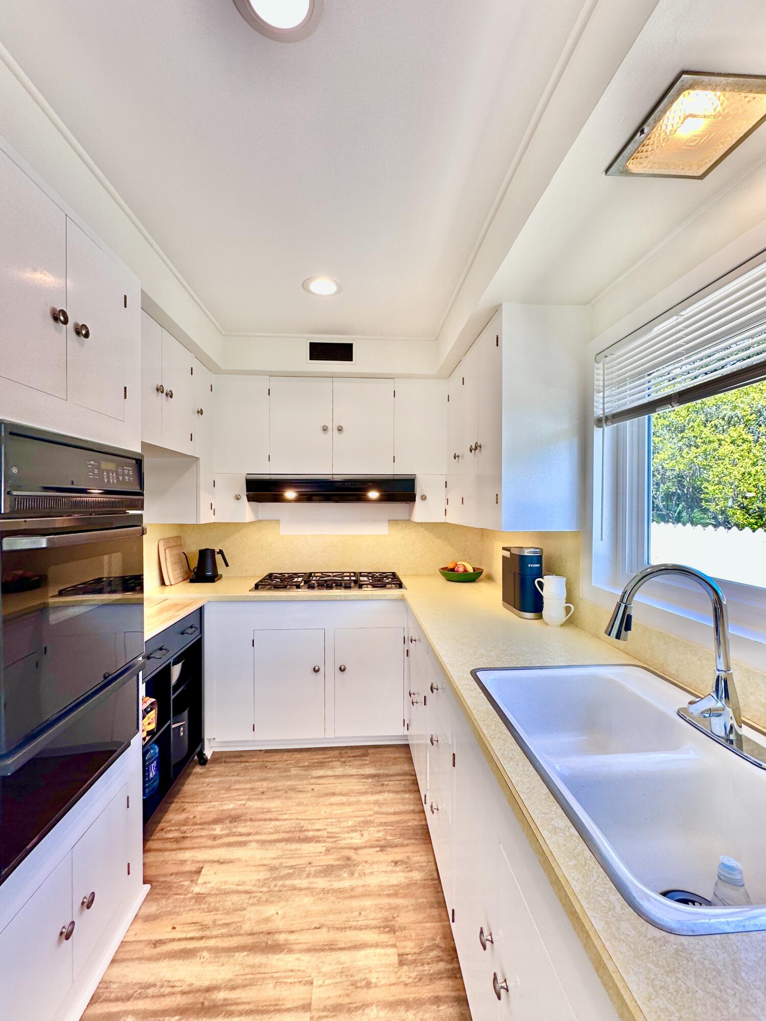 2227 Cliff Drive Santa Barbara, CA 93109 - Photo 10 of 26 a large kitchen with stainless steel appliances granite countertop a sink and cabinets