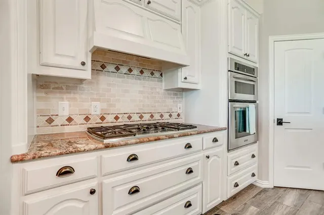a white stove top oven sitting inside of a kitchen